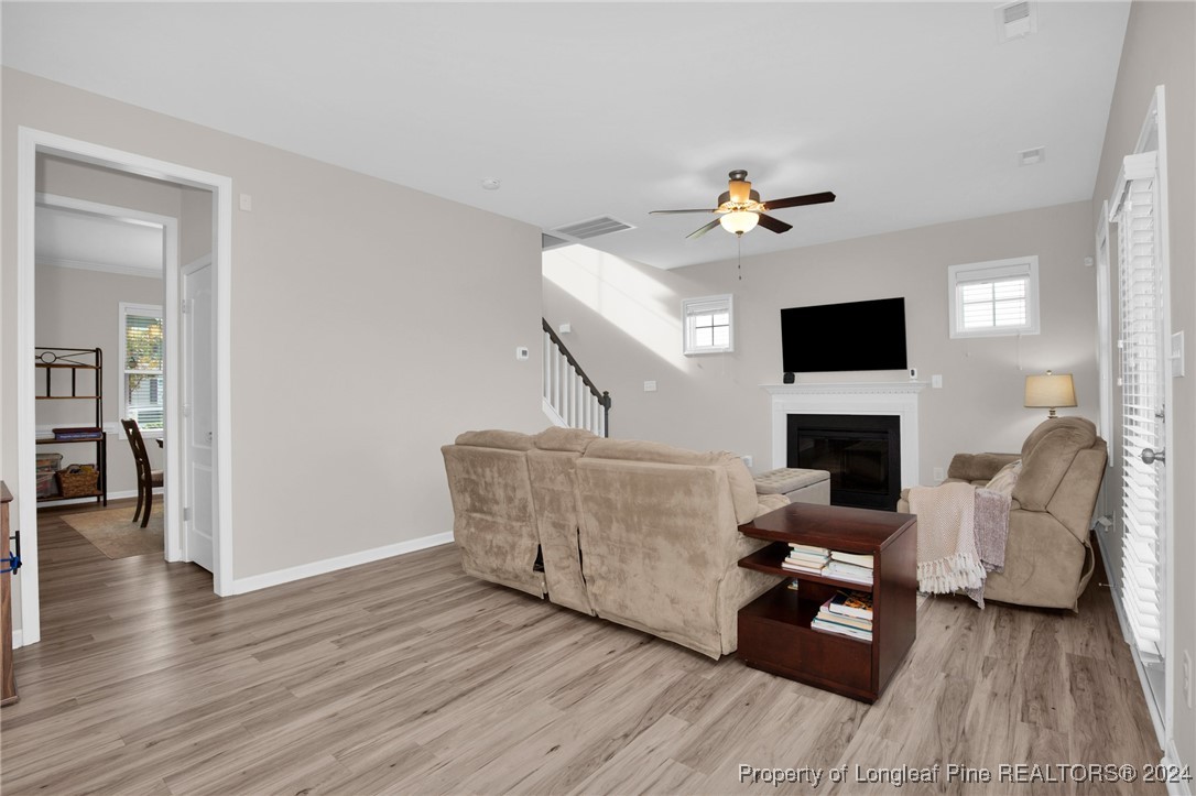 181 Chatfield Dr. Raeford, NC 28376 - Photo 7 of 36 a living room with furniture a fireplace and a flat screen tv