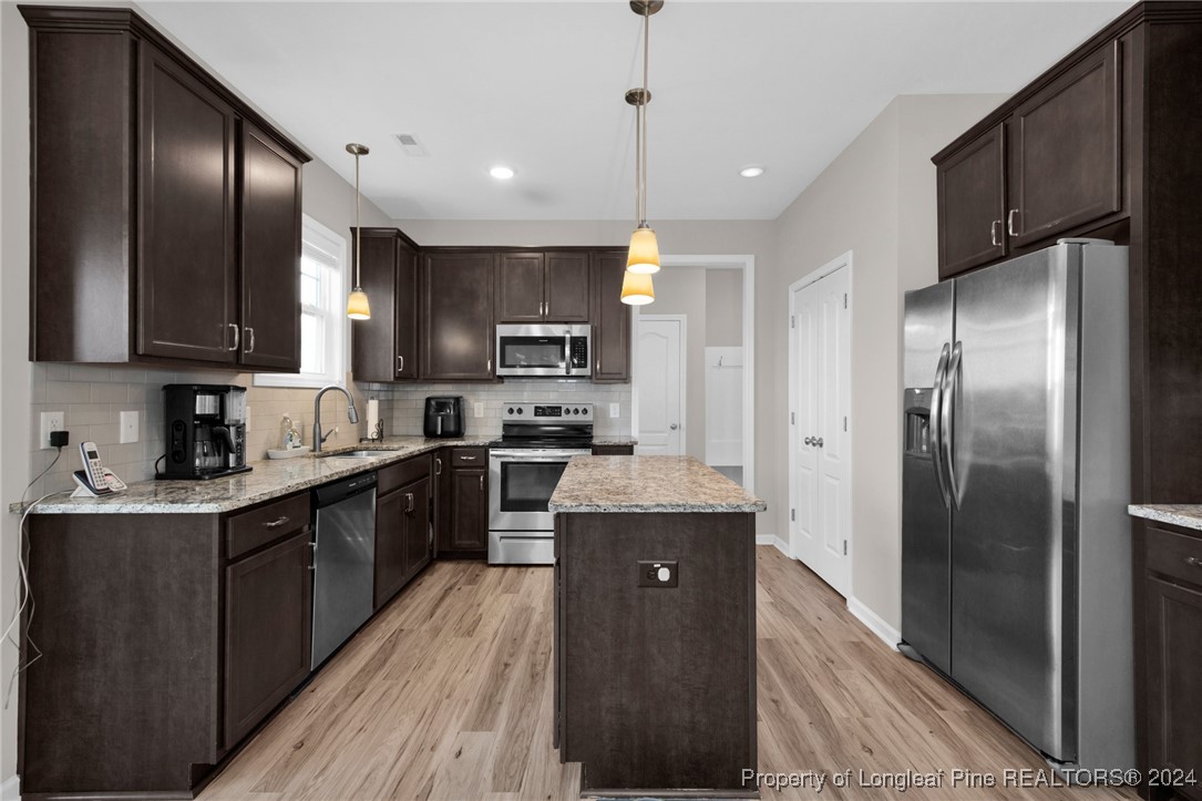 181 Chatfield Dr. Raeford, NC 28376 - Photo 10 of 36 a kitchen with stainless steel appliances granite countertop a refrigerator a sink dishwasher a stove and a refrigerator with wooden floor