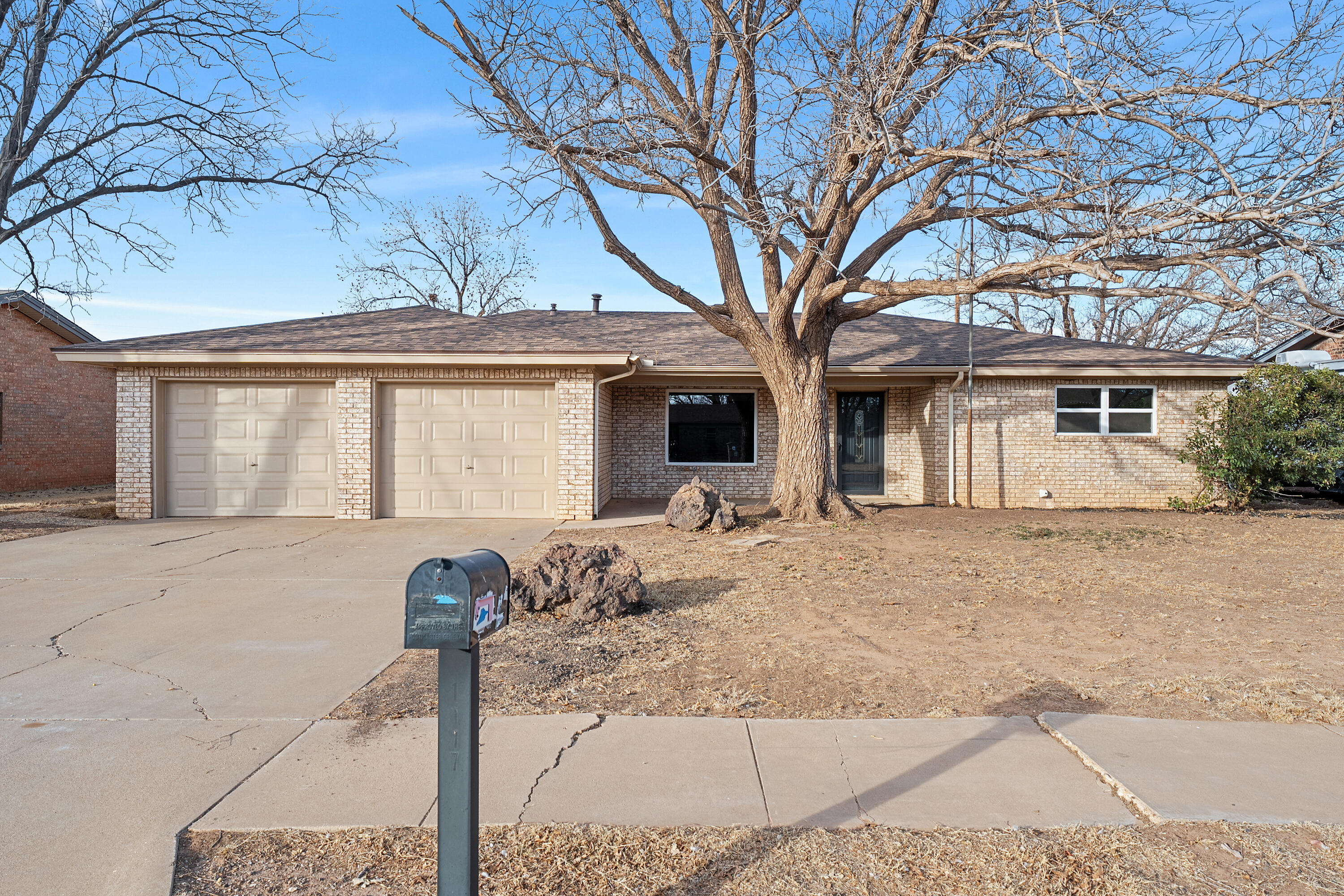 1117 15th Street Shallowater, TX 79363 - Photo 1 of 23 a front view of a house with garden