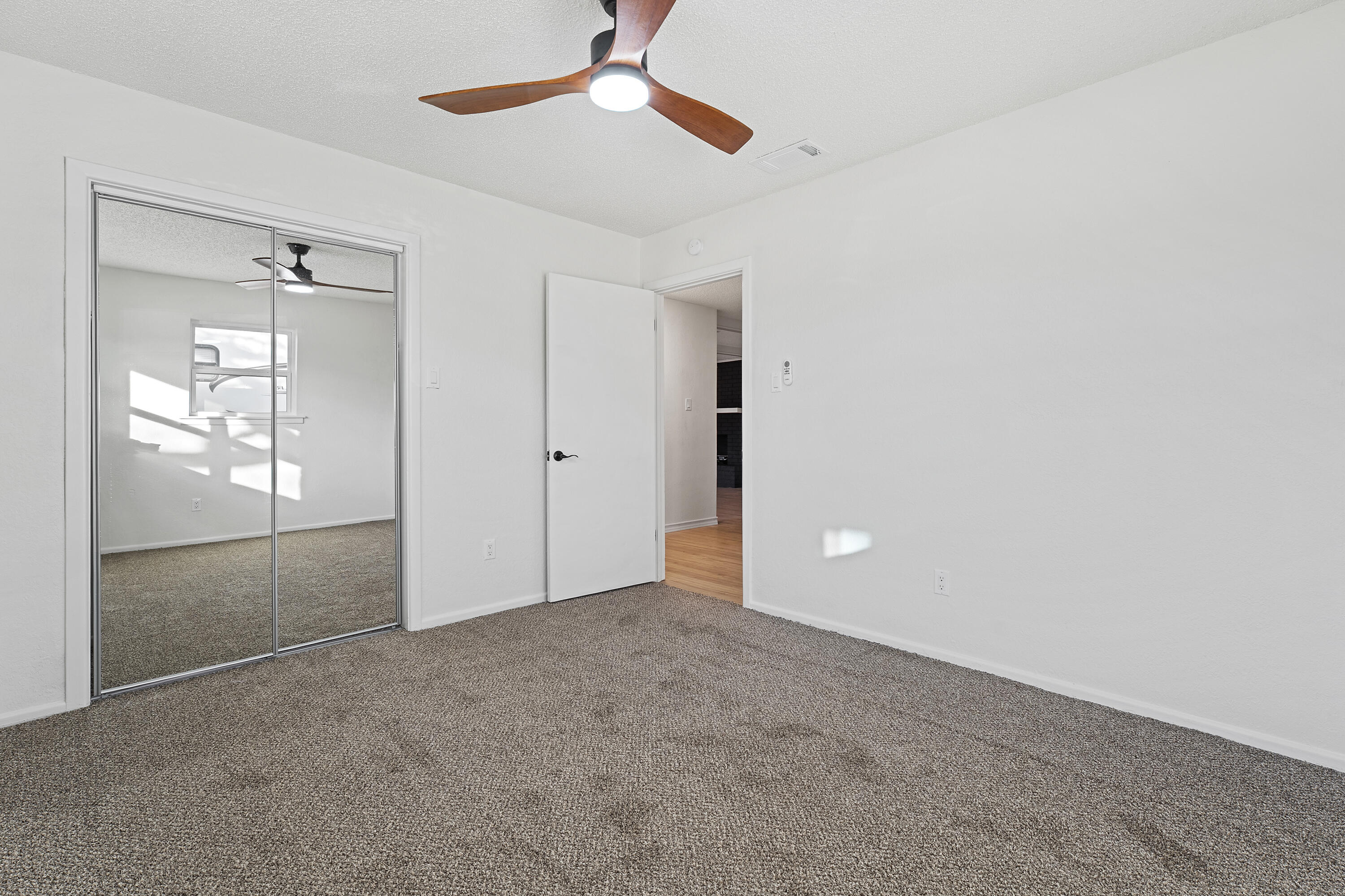 1117 15th Street Shallowater, TX 79363 - Photo 20 of 23 an empty room with closet and a chandelier fan