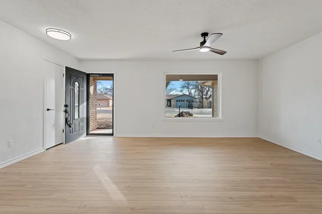 wooden floor in an empty room with a window