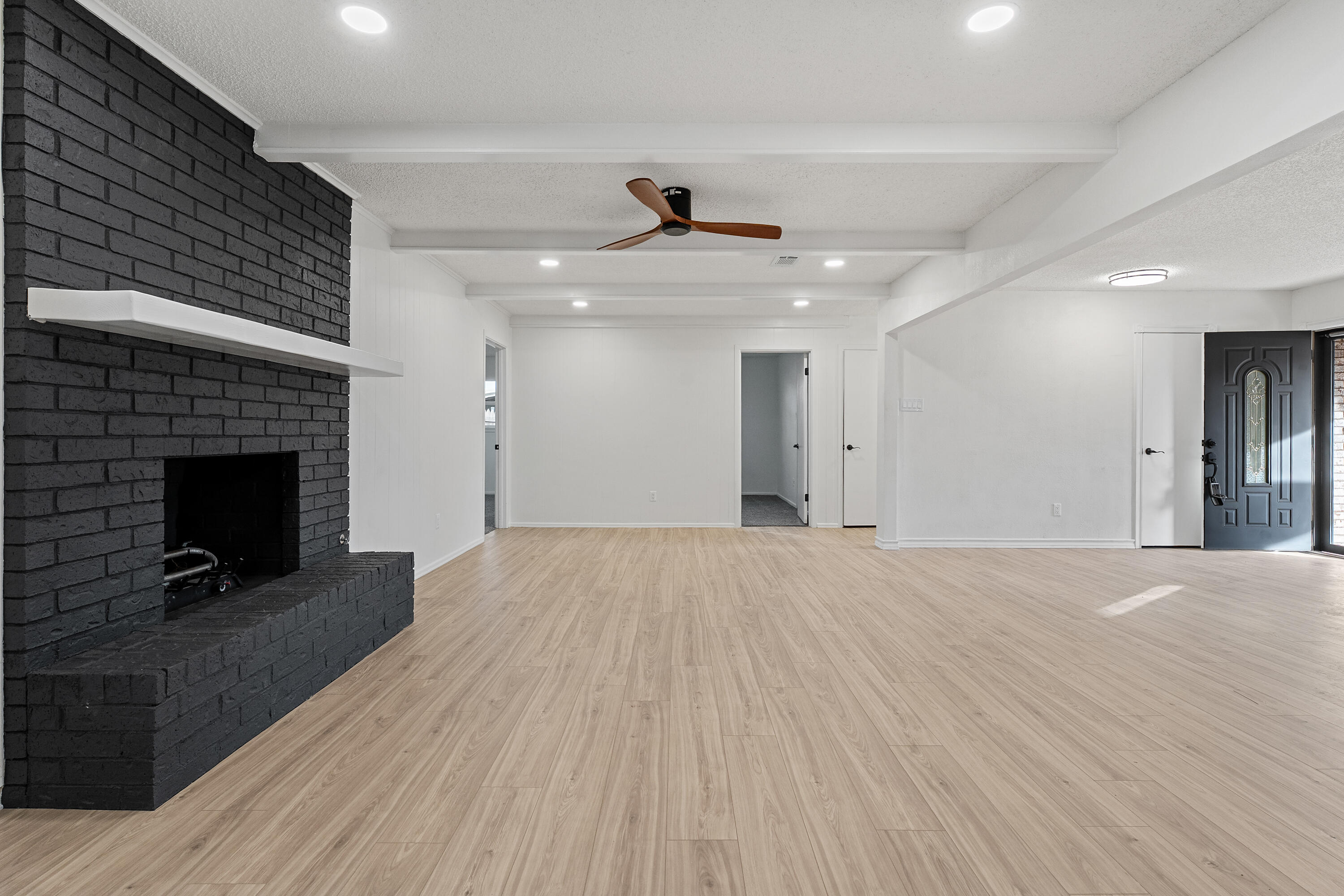 1117 15th Street Shallowater, TX 79363 - Photo 7 of 23 a view of an empty room with wooden floor and a fireplace