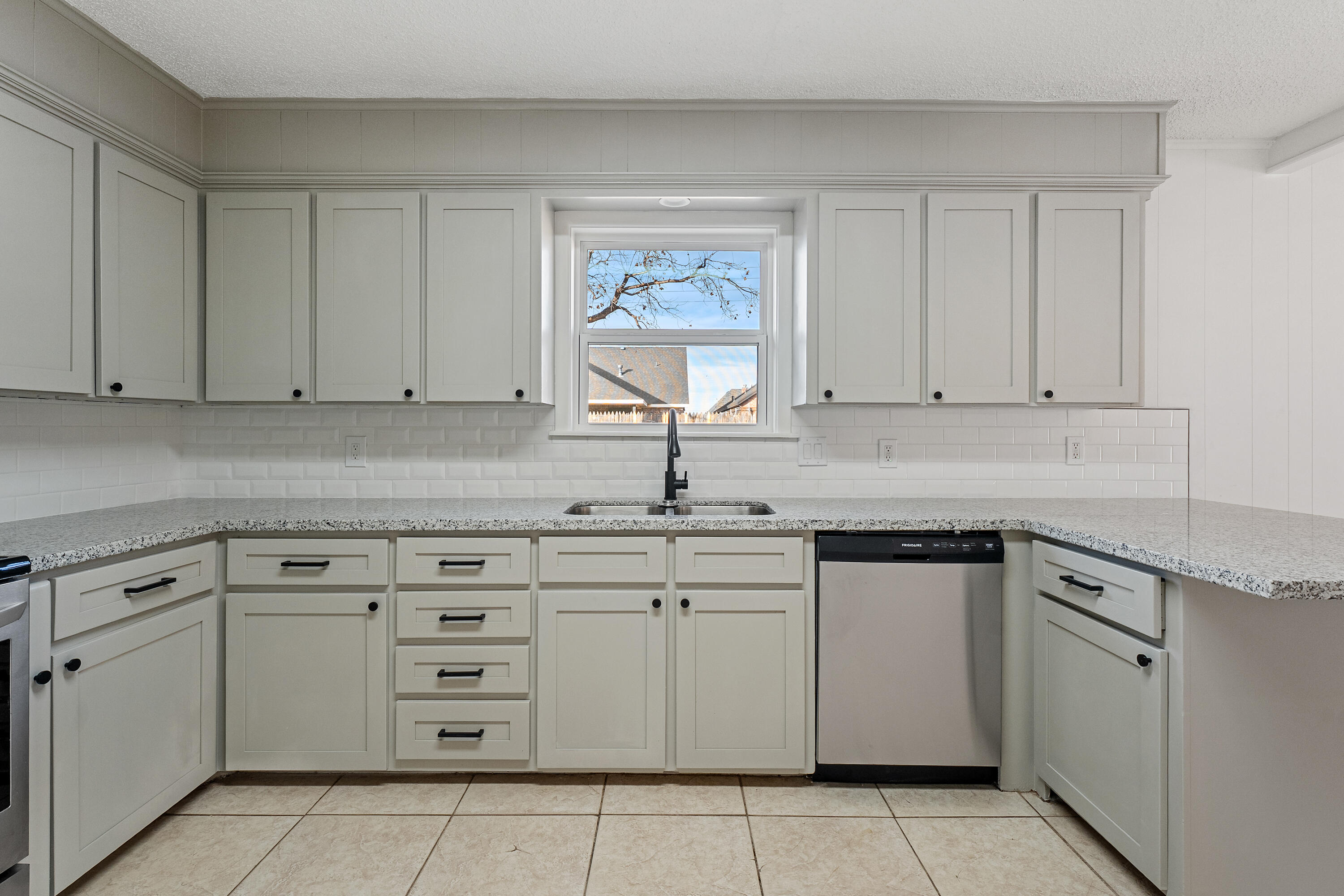1117 15th Street Shallowater, TX 79363 - Photo 10 of 23 a kitchen with cabinets appliances a sink and a counter top