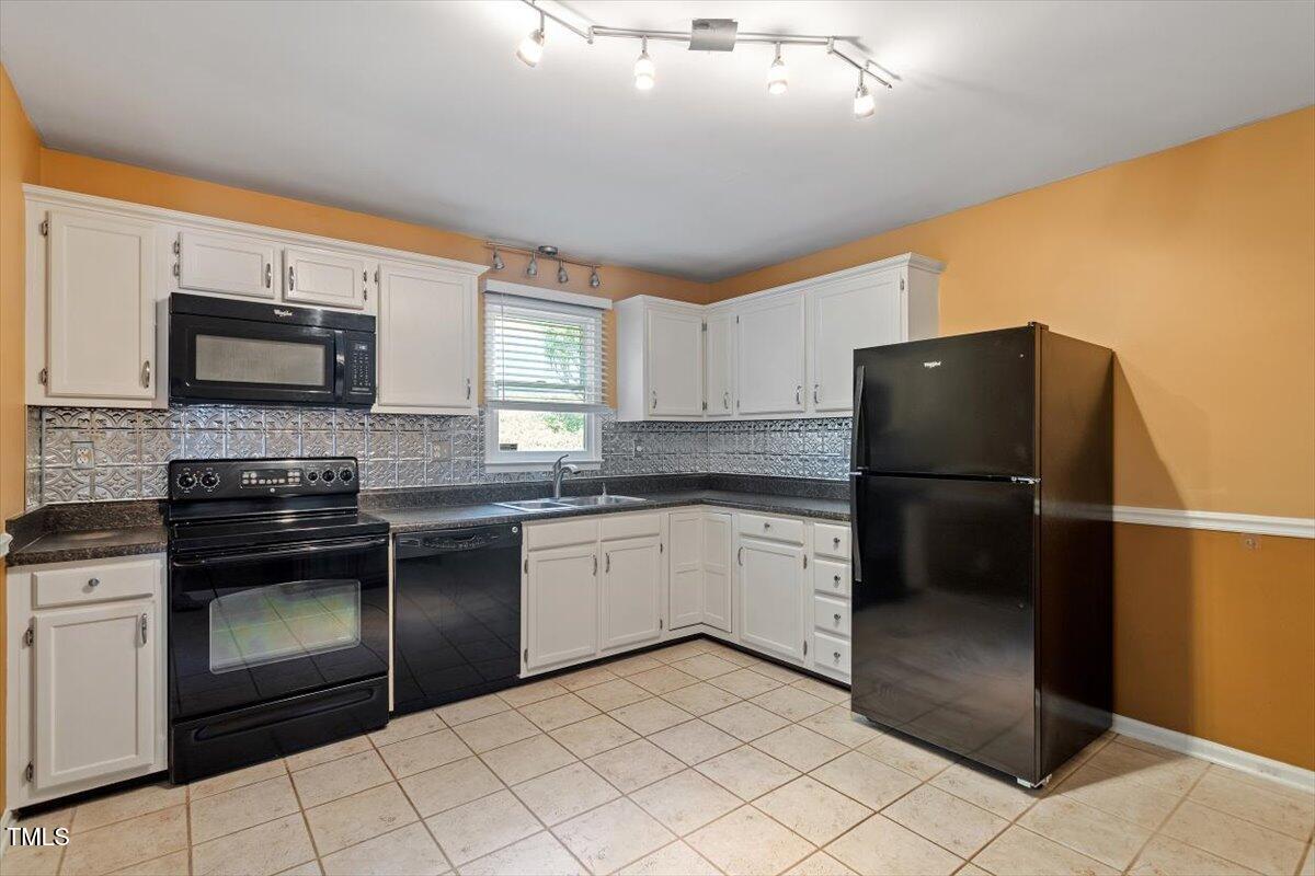 721 Tan Tara Square Raleigh, NC 27615 - Photo 11 of 26 a kitchen with granite countertop a refrigerator stove and microwave