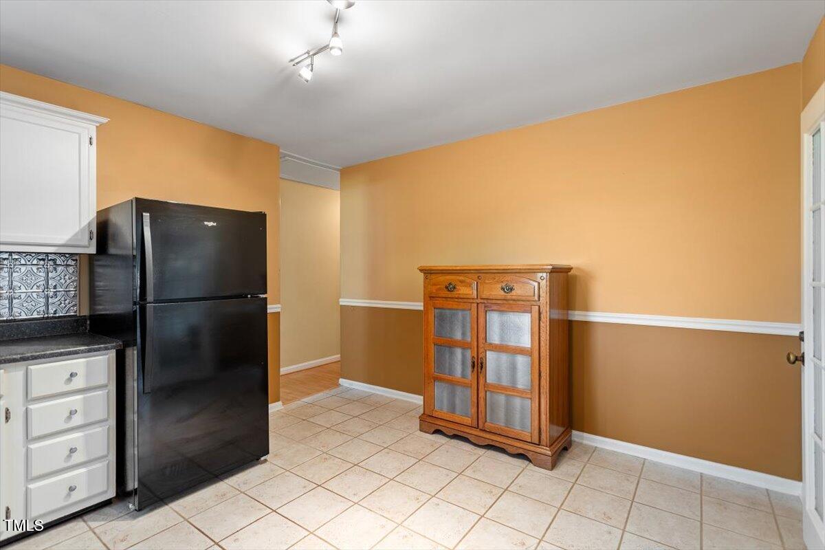 721 Tan Tara Square Raleigh, NC 27615 - Photo 12 of 26 a kitchen with stainless steel appliances granite countertop a refrigerator and a sink