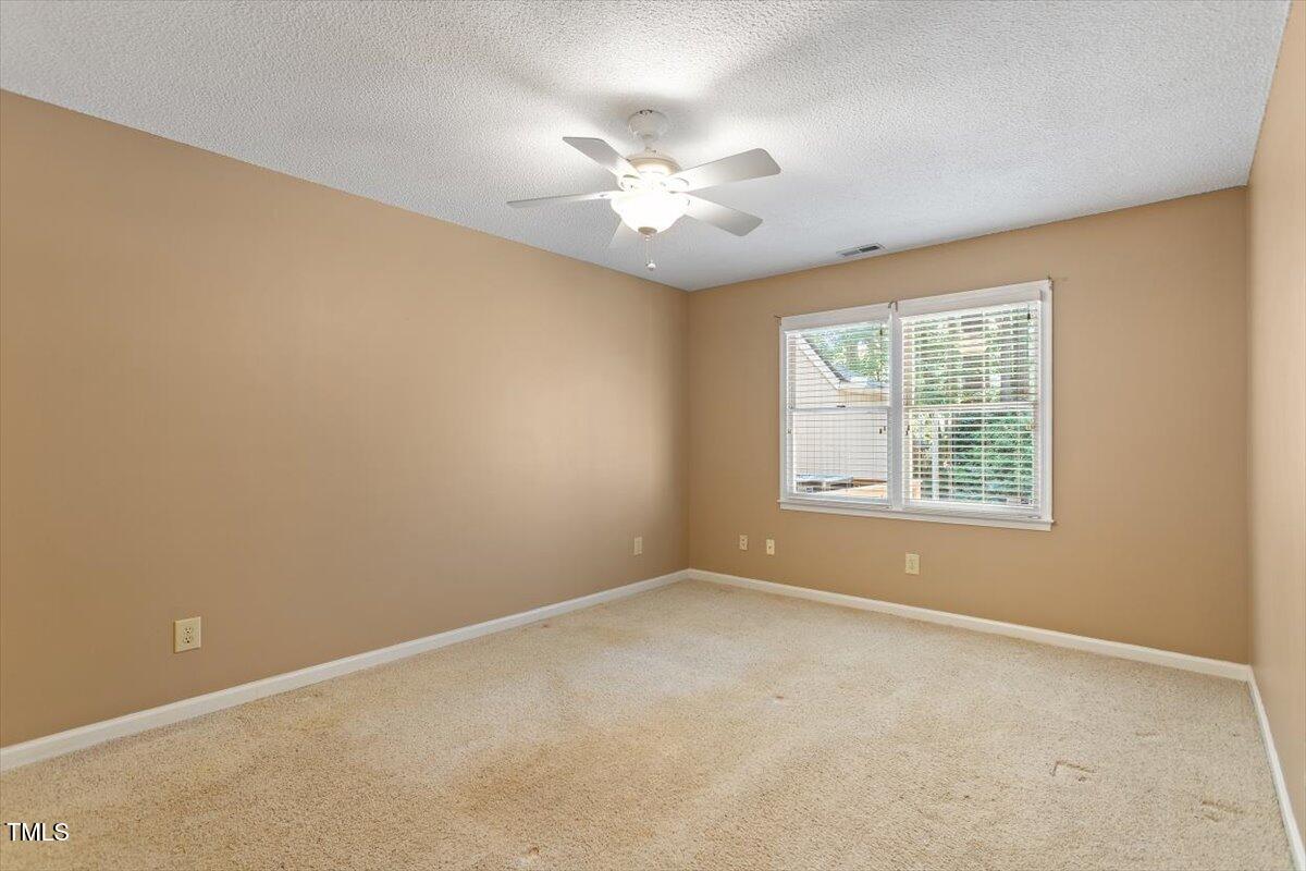 721 Tan Tara Square Raleigh, NC 27615 - Photo 18 of 26 an empty room with a window and a fan