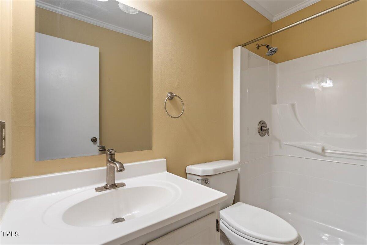 721 Tan Tara Square Raleigh, NC 27615 - Photo 21 of 26 a bathroom with a sink toilet and shower