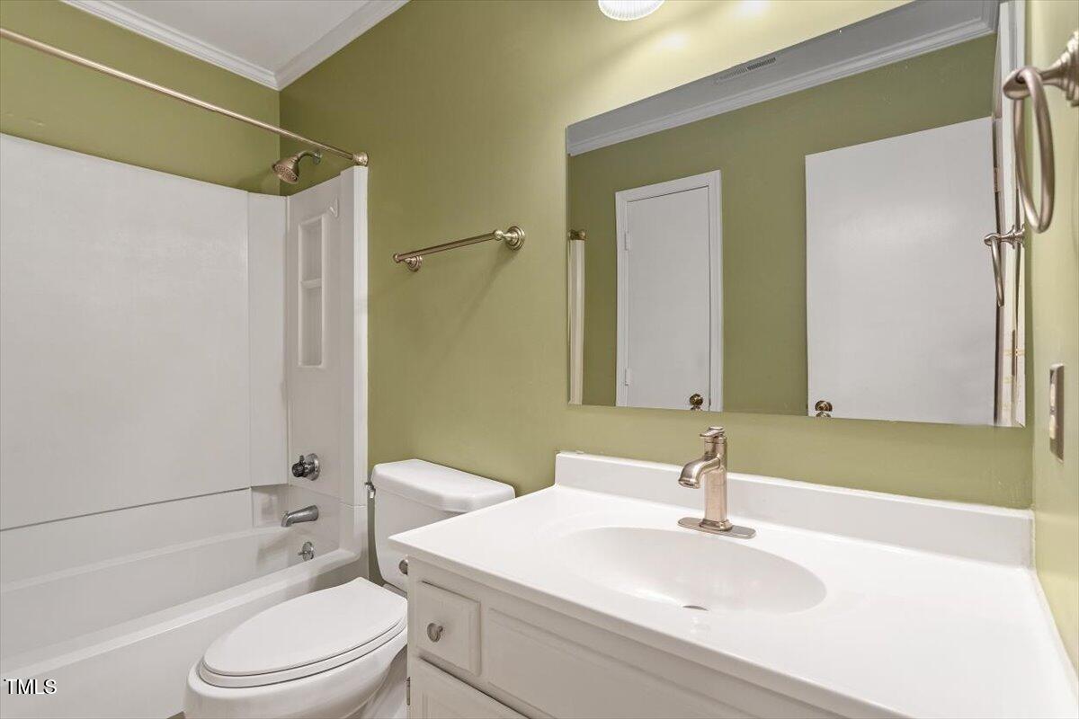 721 Tan Tara Square Raleigh, NC 27615 - Photo 24 of 26 a bathroom with a sink toilet and shower