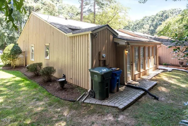 a backyard of a house with yard barbeque oven and outdoor seating