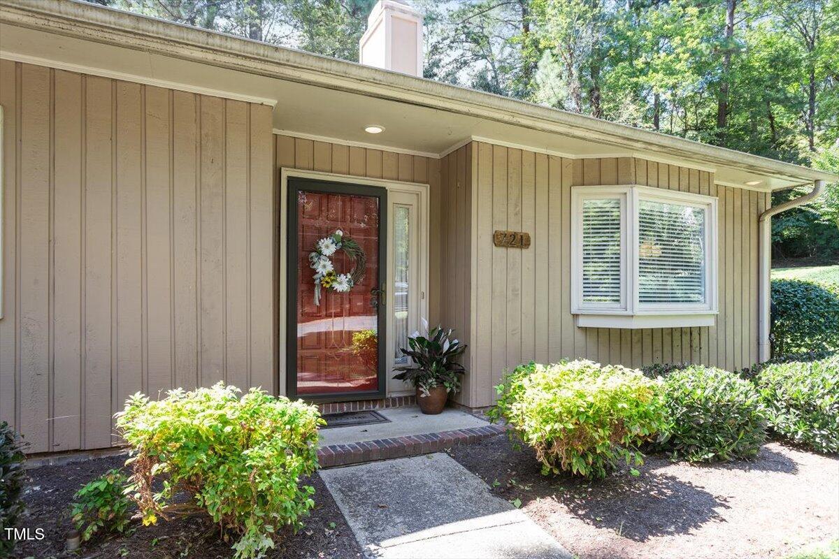 721 Tan Tara Square Raleigh, NC 27615 - Photo 4 of 26 a front view of a house with a garden
