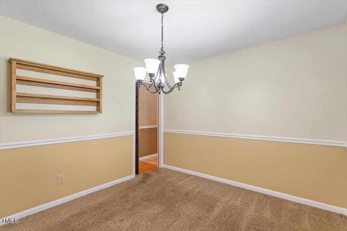 721 Tan Tara Square Raleigh, NC 27615 - Photo 9 of 26 a view of a chandelier in a room