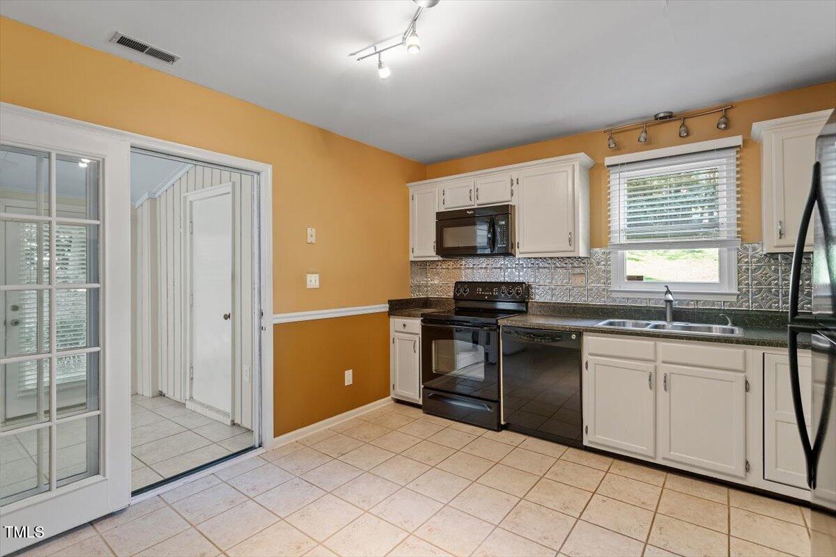 721 Tan Tara Square Raleigh, NC 27615 - Photo 10 of 26 a kitchen with granite countertop a refrigerator and a sink