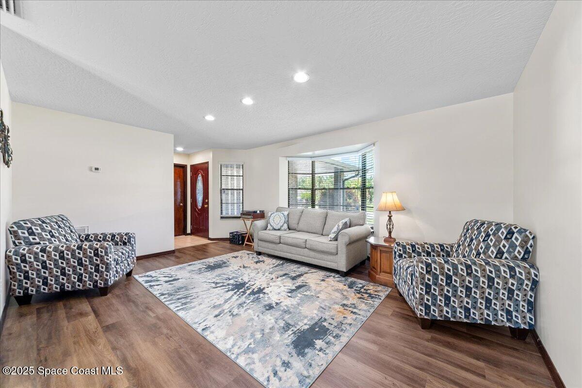 257 Avens Road Northeast Palm Bay, FL 32907 - Photo 12 of 52 a living room with furniture and a couch