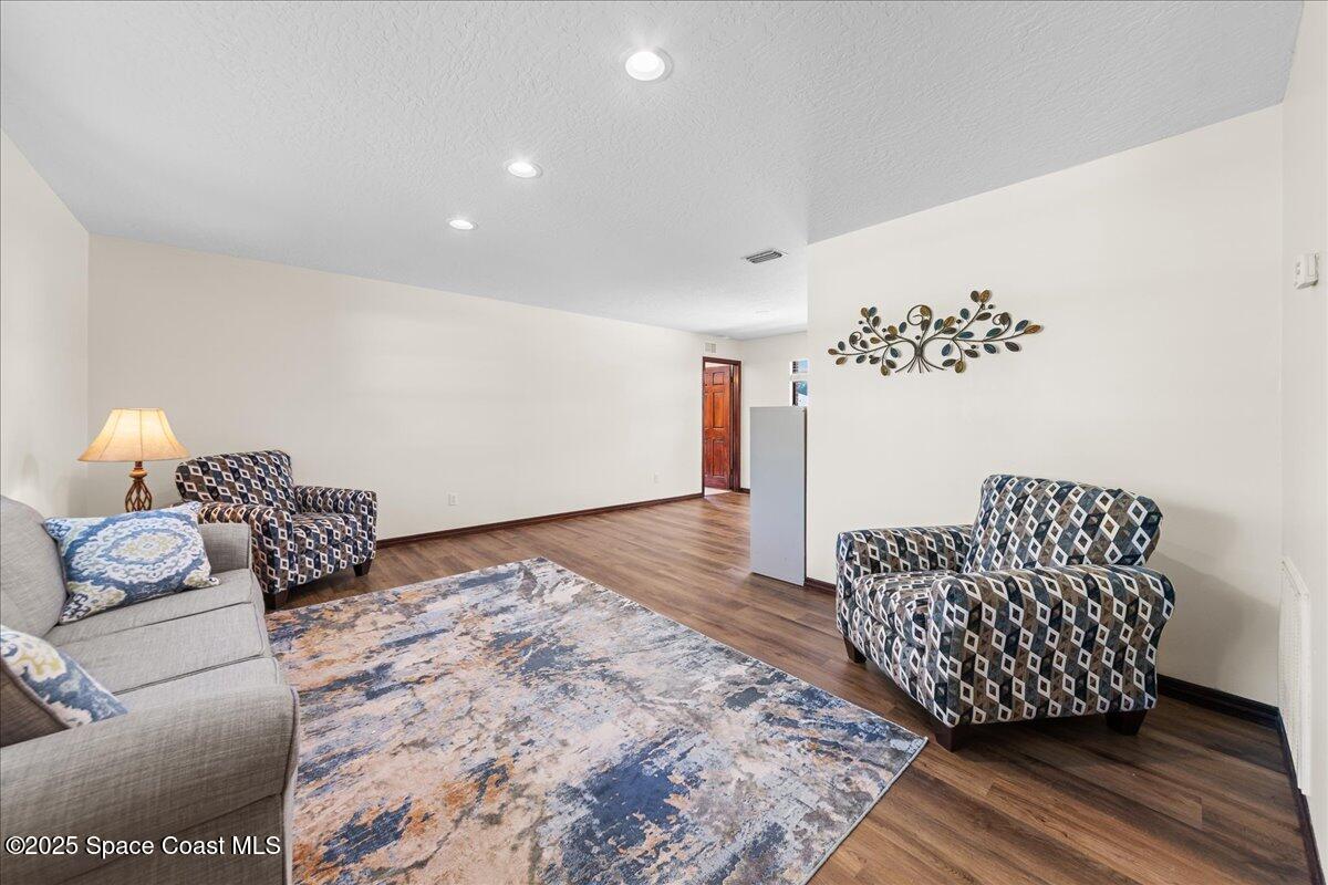 257 Avens Road Northeast Palm Bay, FL 32907 - Photo 14 of 52 a bedroom with a bed and a couch