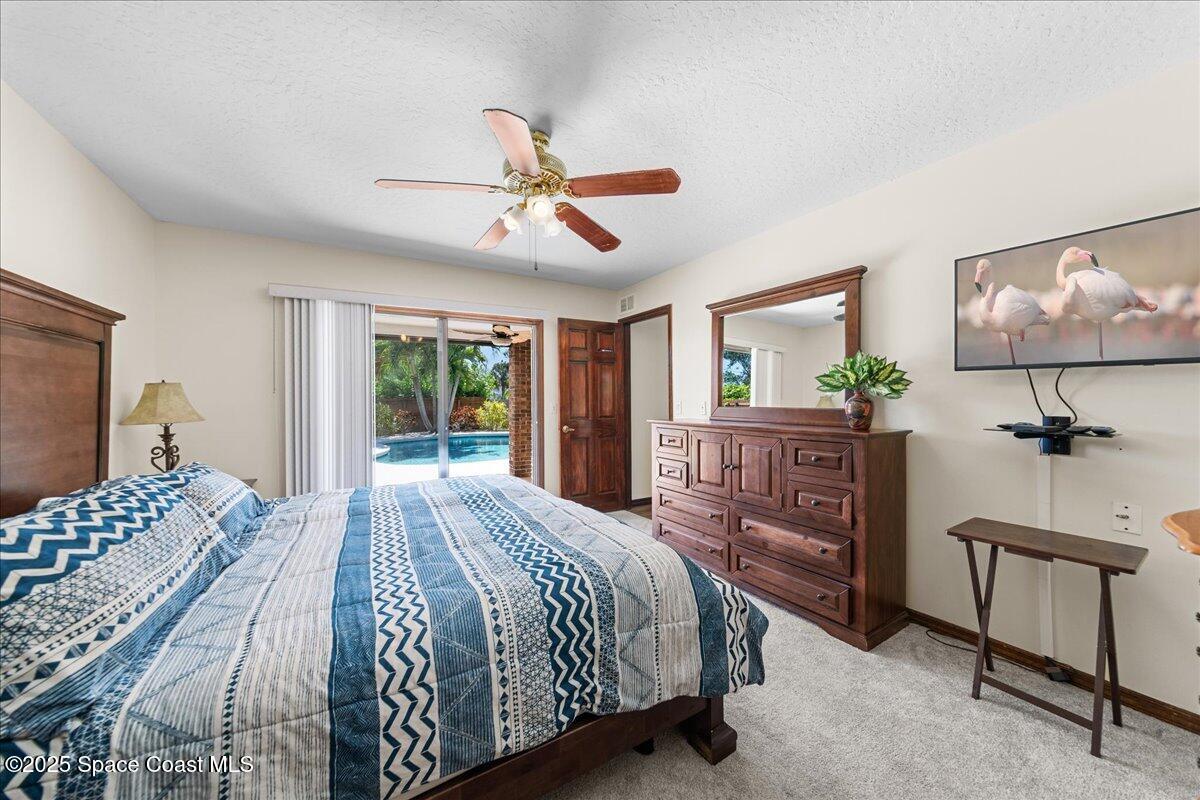 257 Avens Road Northeast Palm Bay, FL 32907 - Photo 18 of 52 a bedroom with a bed a dresser and next to a window