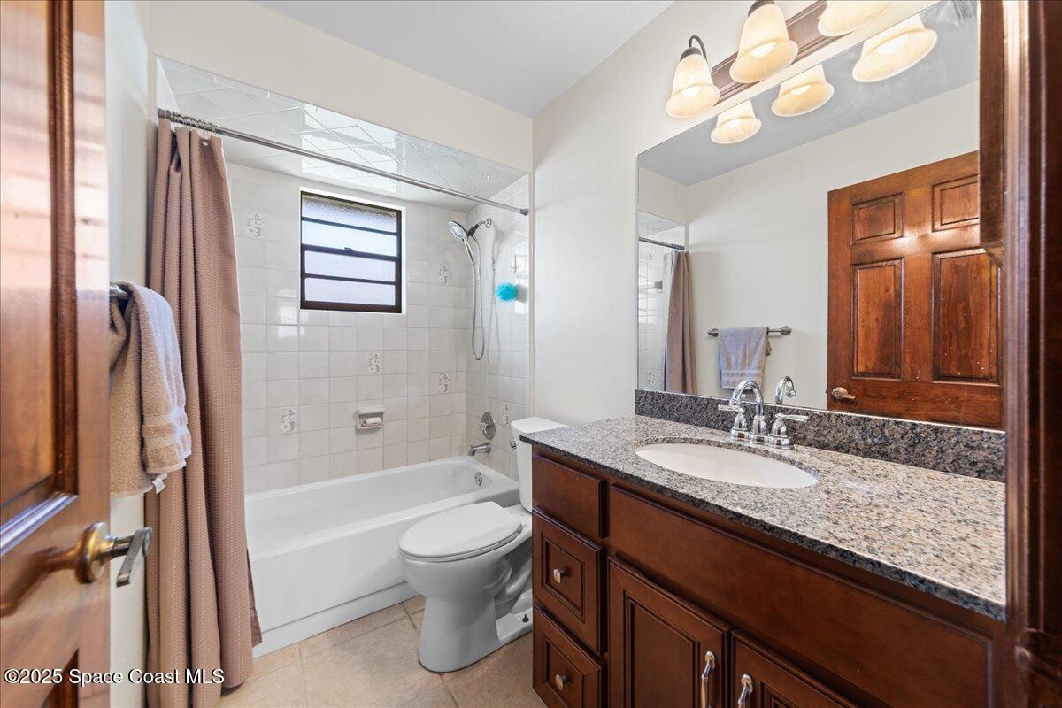 257 Avens Road Northeast Palm Bay, FL 32907 - Photo 23 of 52 a bathroom with a granite countertop sink toilet and shower