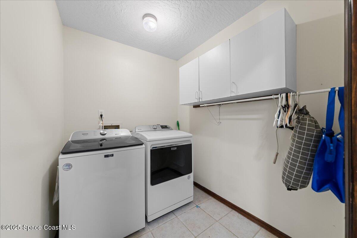 257 Avens Road Northeast Palm Bay, FL 32907 - Photo 25 of 52 a utility room with dryer and washer