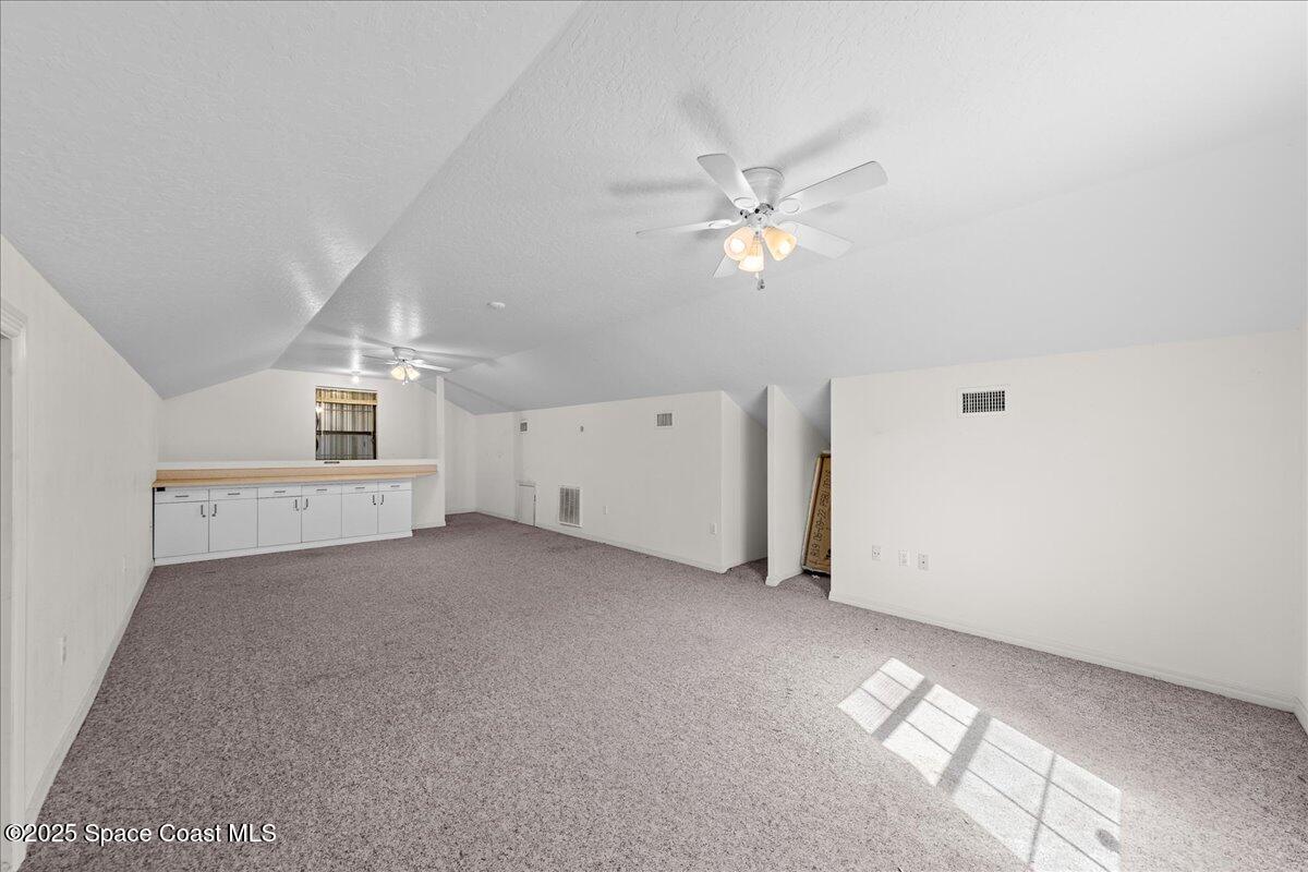 257 Avens Road Northeast Palm Bay, FL 32907 - Photo 32 of 52 an empty room with a empty space and a ceiling fan