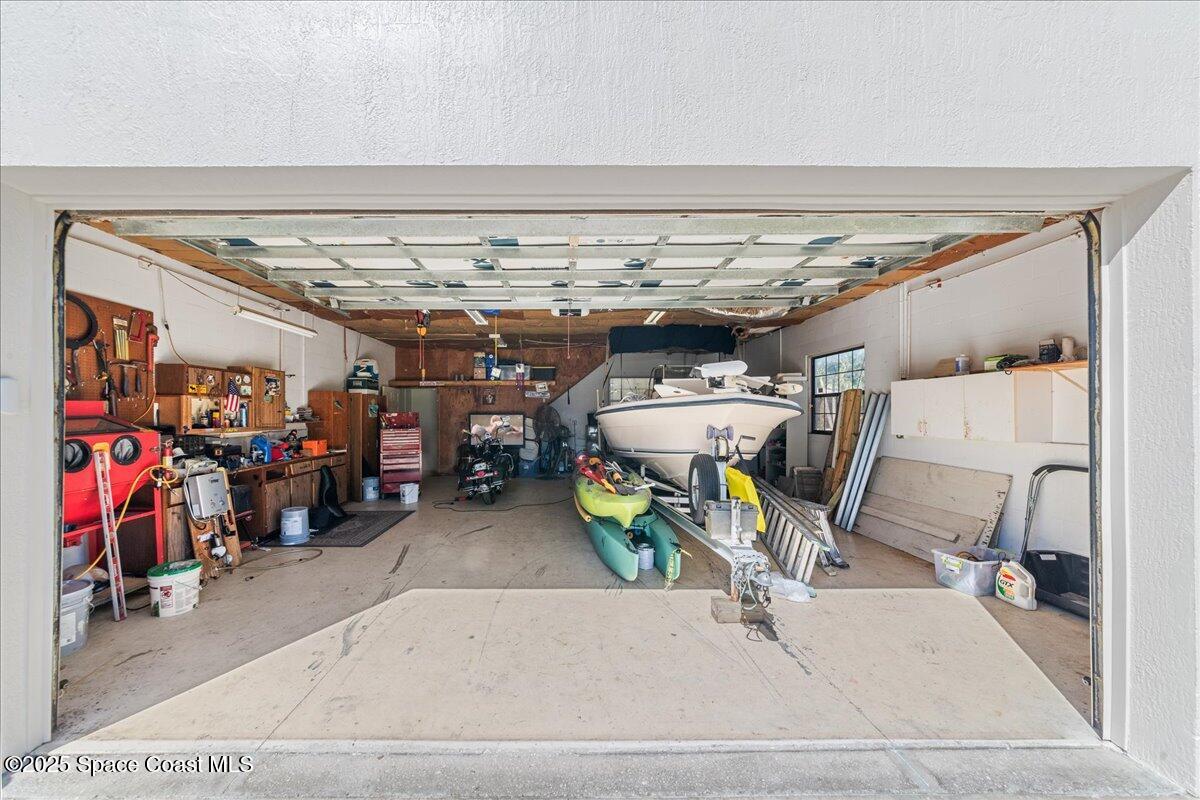 257 Avens Road Northeast Palm Bay, FL 32907 - Photo 34 of 52 a view of a garage with a white car