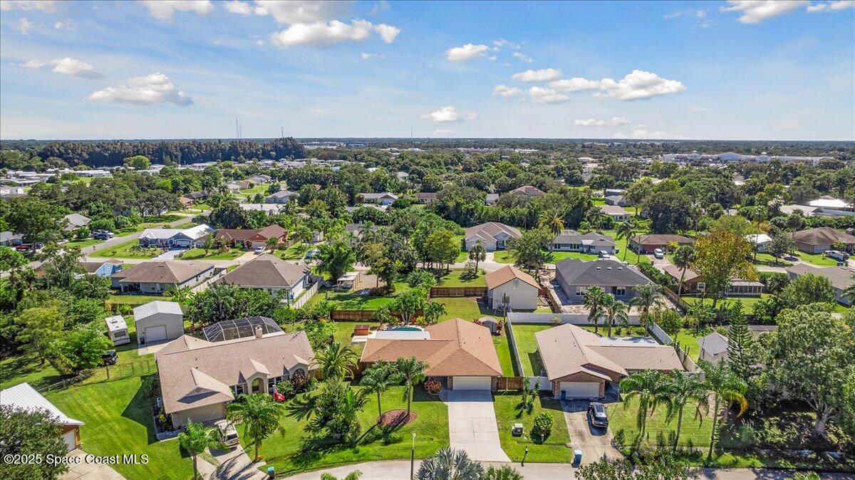 257 Avens Road Northeast Palm Bay, FL 32907 - Photo 37 of 52 an aerial view of residential houses with outdoor space and trees