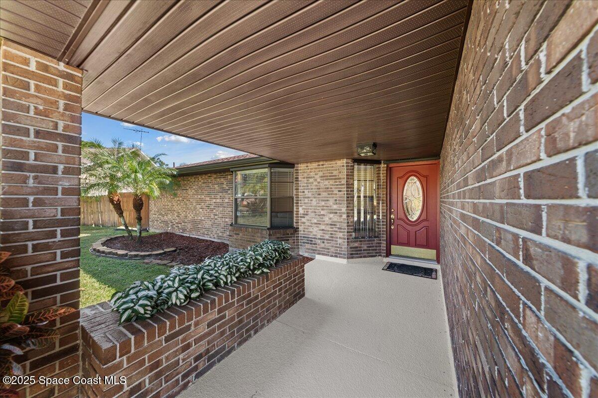 257 Avens Road Northeast Palm Bay, FL 32907 - Photo 4 of 52 a front view of a house with garden