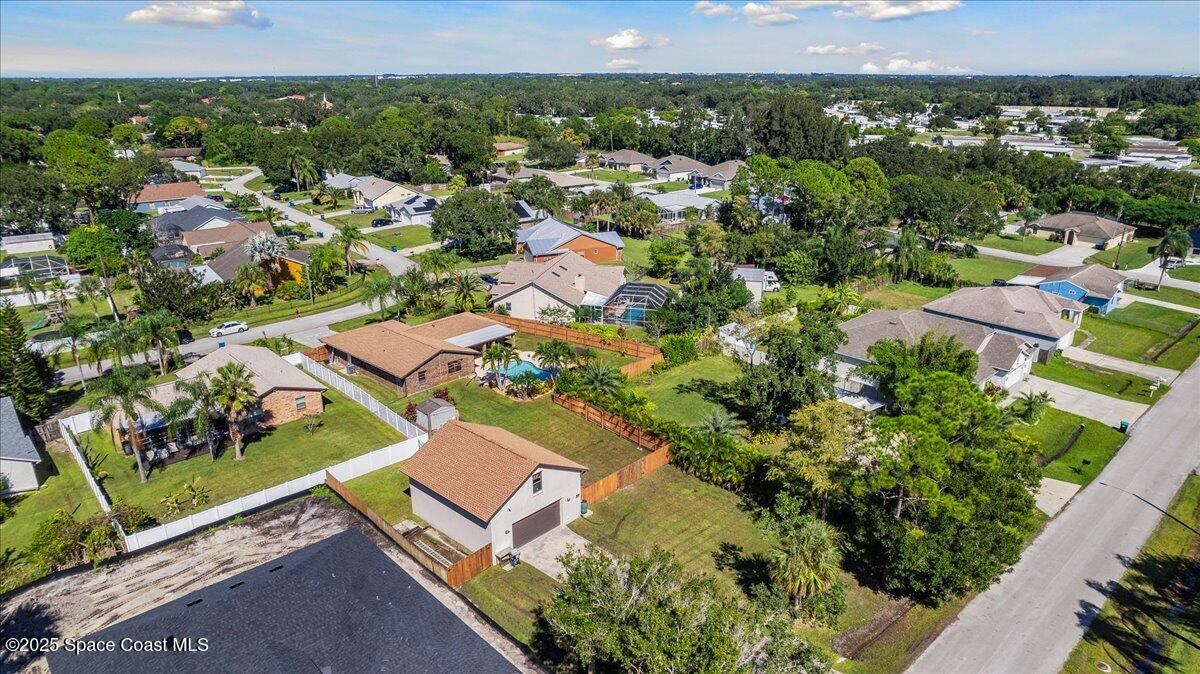 257 Avens Road Northeast Palm Bay, FL 32907 - Photo 41 of 52 an aerial view of residential houses with outdoor space