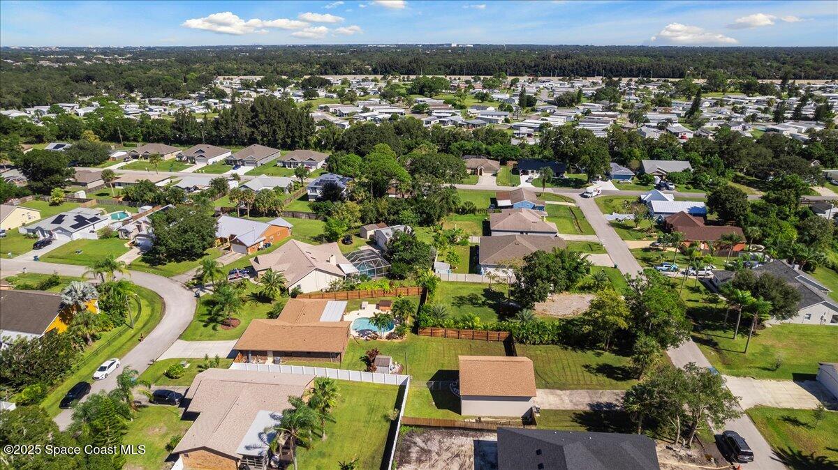 257 Avens Road Northeast Palm Bay, FL 32907 - Photo 44 of 52 an aerial view of residential houses with outdoor space and trees