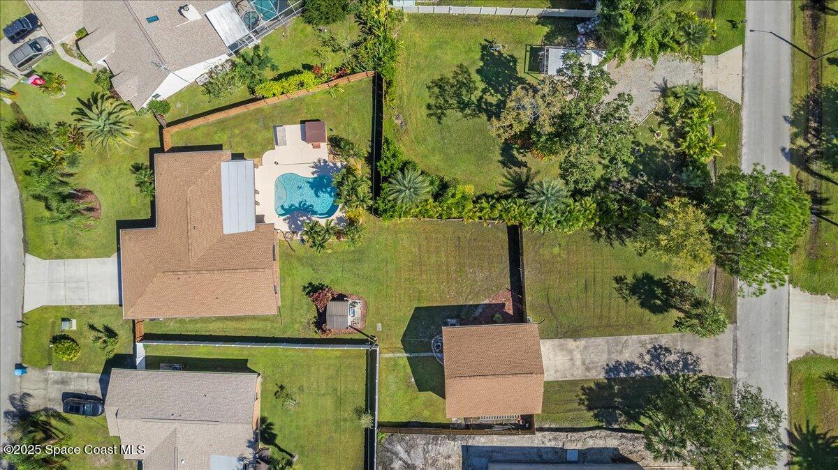 257 Avens Road Northeast Palm Bay, FL 32907 - Photo 45 of 52 an aerial view of a house with a garden and trees