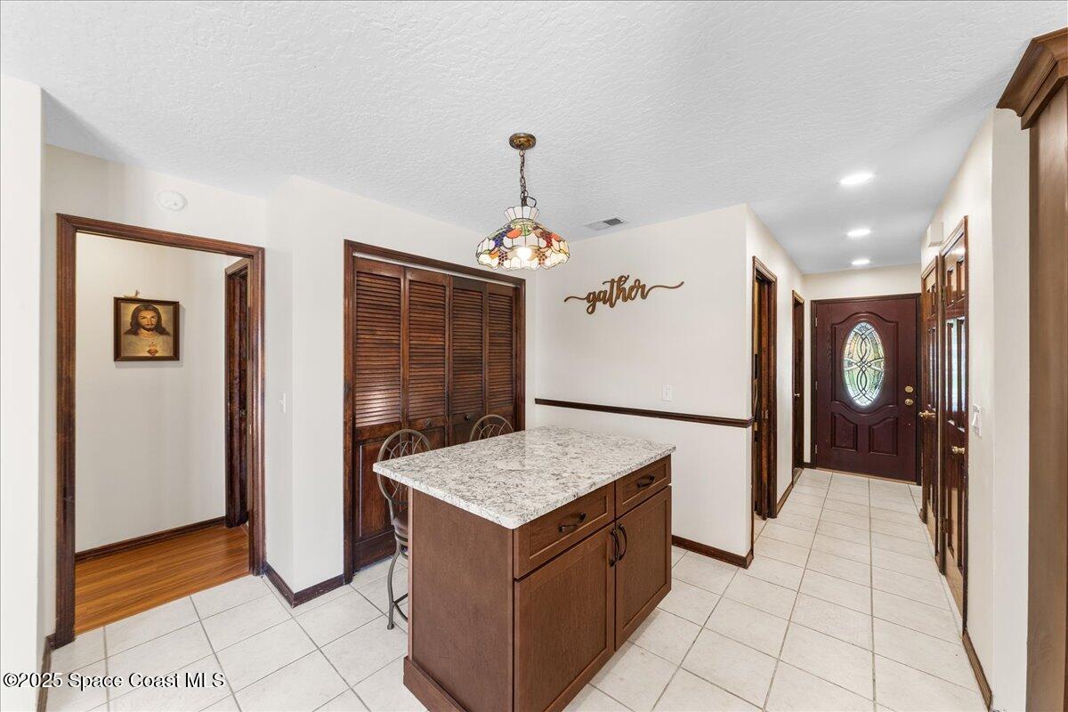257 Avens Road Northeast Palm Bay, FL 32907 - Photo 7 of 52 a kitchen with granite countertop a refrigerator a sink and a stove