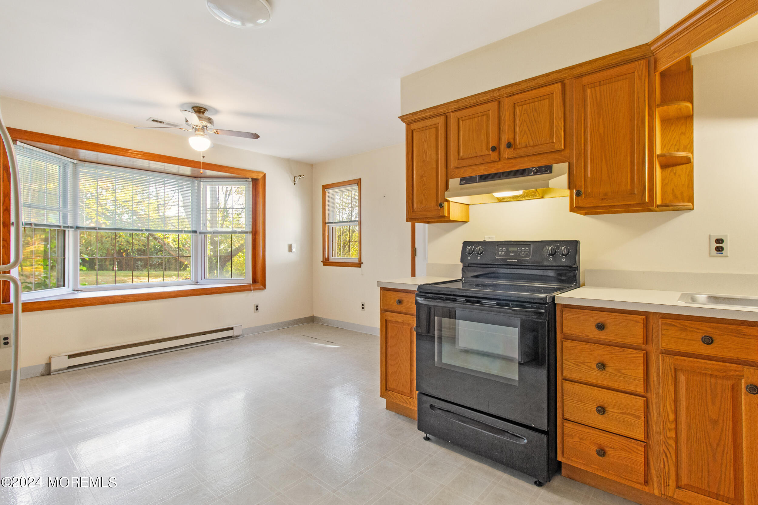 57 Quaker Road Mickleton, NJ 08056 - Photo 12 of 41 a kitchen with stainless steel appliances granite countertop a stove a sink and a refrigerator with wooden cabinets