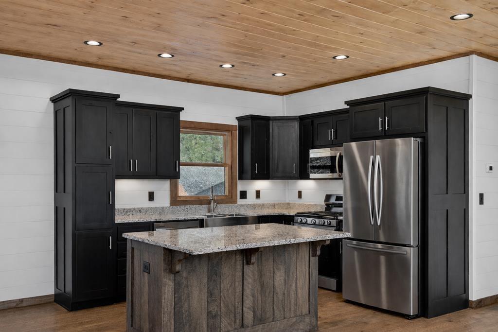 142 Red Oak Trail Ellijay, GA 30540 - Photo 14 of 63 a kitchen with granite countertop a refrigerator and a sink