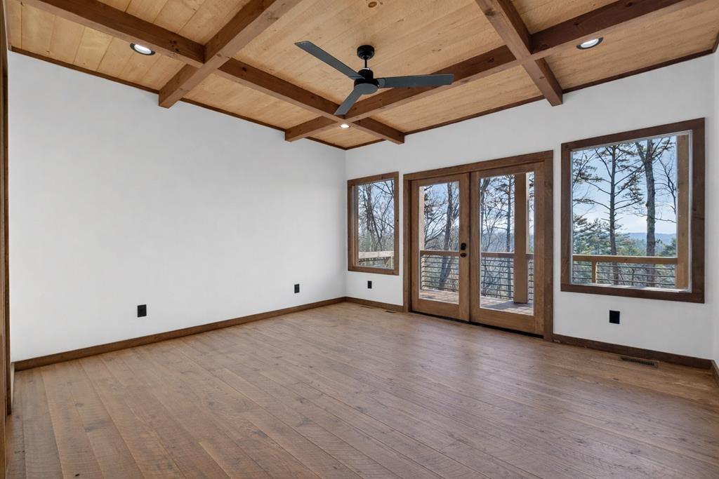 142 Red Oak Trail Ellijay, GA 30540 - Photo 17 of 63 a view of an empty room with a window and wooden floor