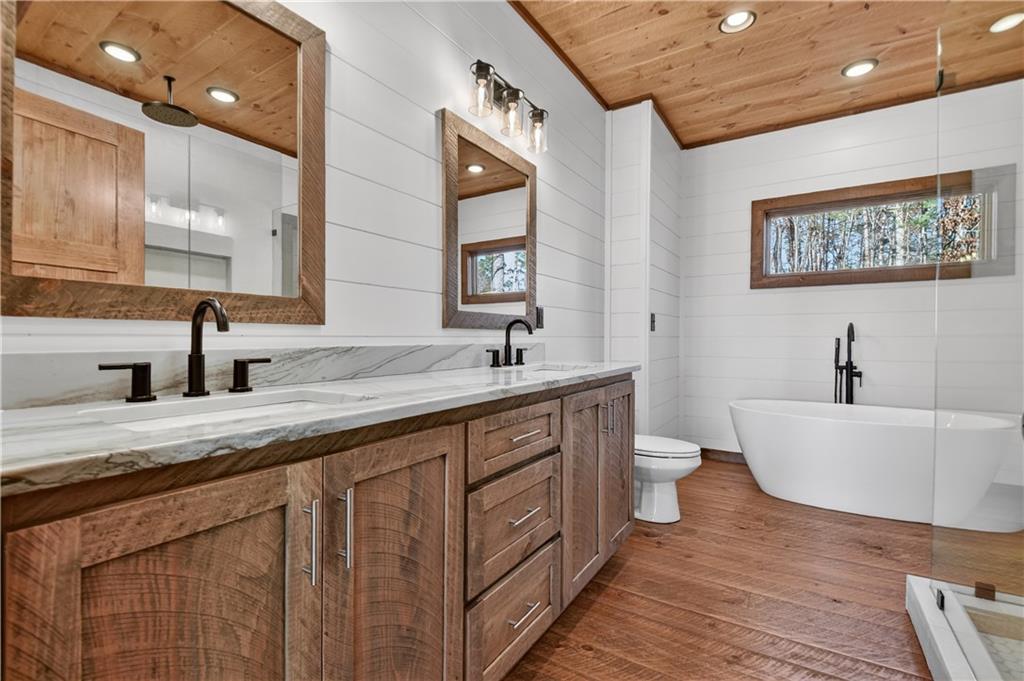 142 Red Oak Trail Ellijay, GA 30540 - Photo 18 of 63 a spacious bathroom with a double vanity sink and a bathtub