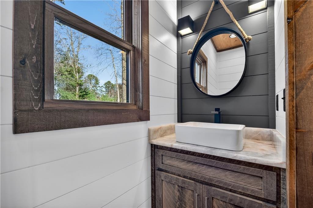 142 Red Oak Trail Ellijay, GA 30540 - Photo 22 of 63 a bathroom with a sink and a mirror