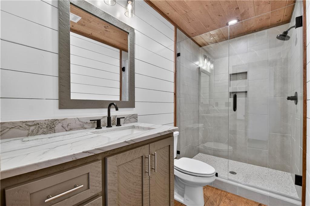 142 Red Oak Trail Ellijay, GA 30540 - Photo 30 of 63 a bathroom with a granite countertop sink toilet and shower