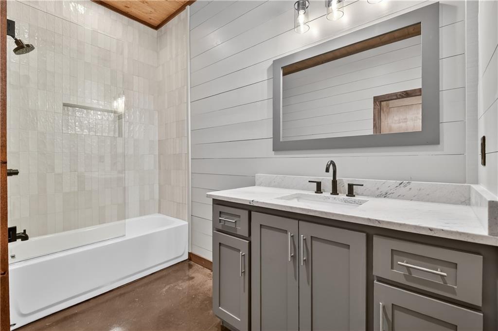 142 Red Oak Trail Ellijay, GA 30540 - Photo 46 of 63 a bathroom with a granite countertop sink mirror and a bathtub