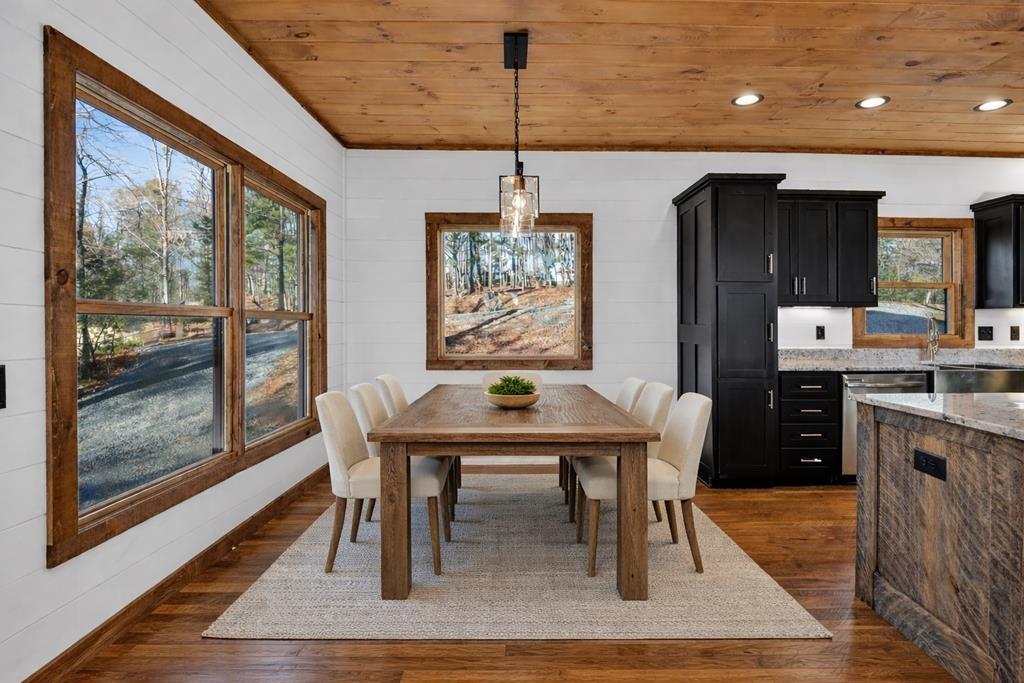 142 Red Oak Trail Ellijay, GA 30540 - Photo 6 of 63 a dining room with furniture a rug and wooden floor