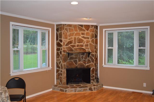 208 Turtle Neck Road Fairview, TN 37062 - Photo 4 of 20 a living room with a fireplace and a window