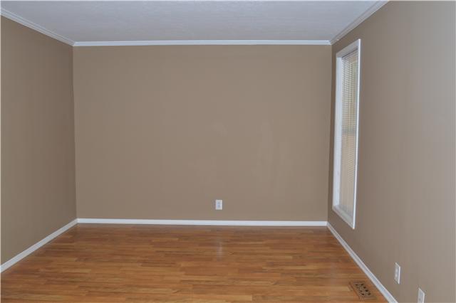 208 Turtle Neck Road Fairview, TN 37062 - Photo 9 of 20 a view of an empty room with wooden floor and a window