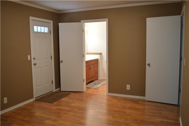 208 Turtle Neck Road Fairview, TN 37062 - Photo 10 of 20 a view of an empty room with wooden floor and a window