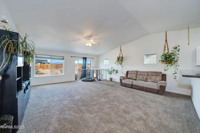 a large white kitchen with stainless steel appliances granite countertop a stove and a sink