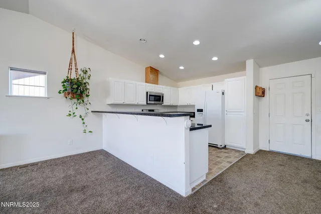 a kitchen with a refrigerator and a stove
