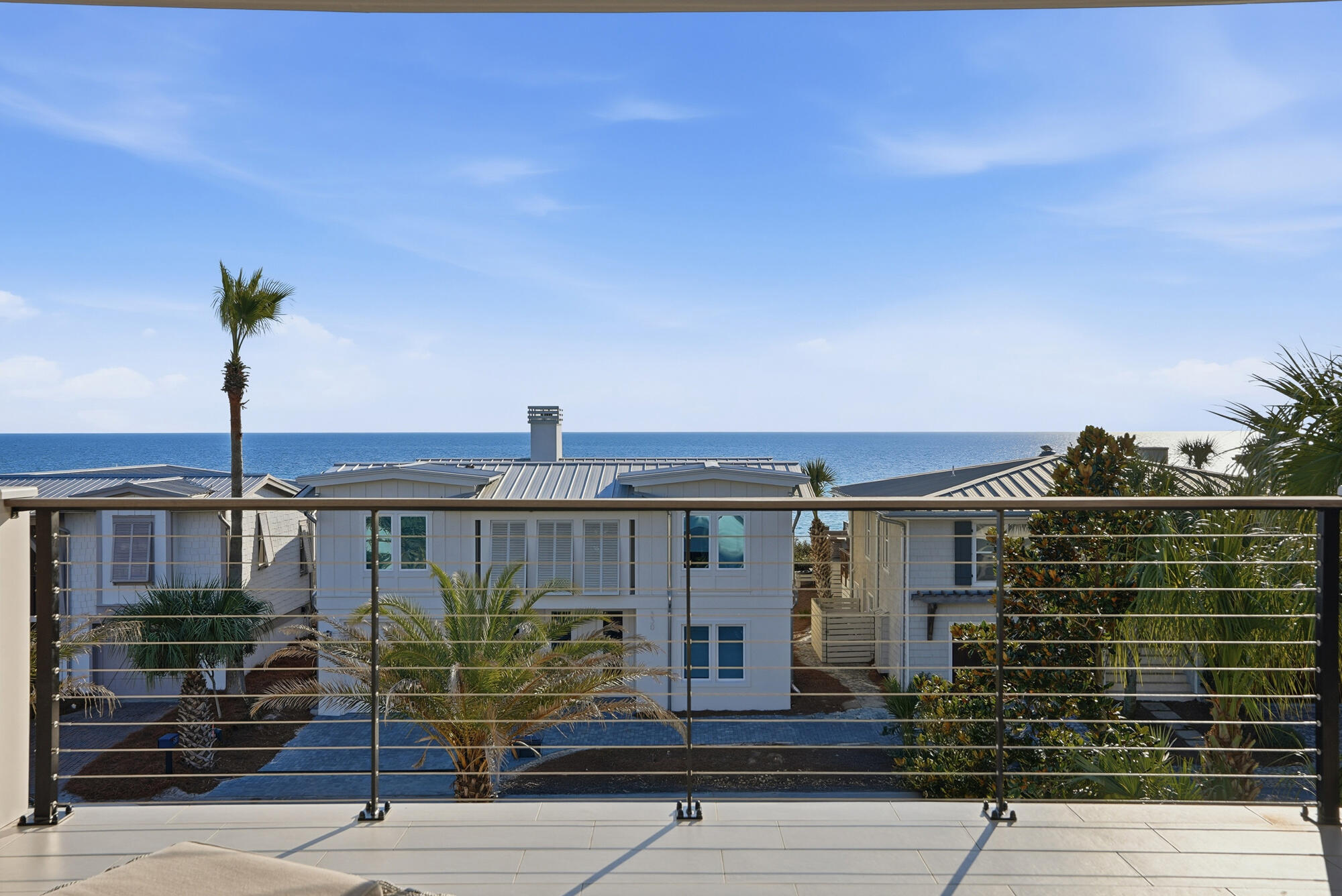 327 Sand Cliffs Drive Inlet Beach, FL 32461 - Photo 58 of 70 a view of a balcony with floor to ceiling windows and wooden floor