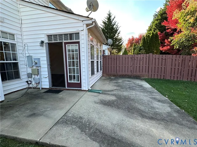 a view of backyard with small cabin and wooden fence
