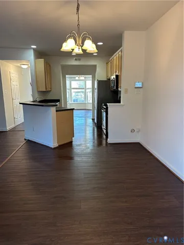 a view of kitchen and dining room with wooden floor