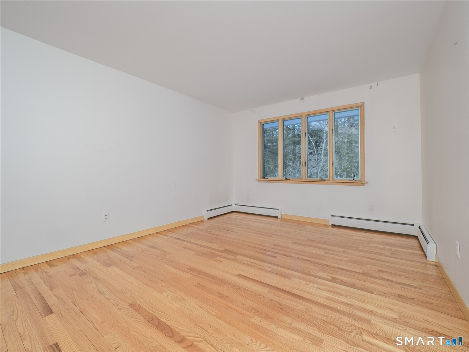 78 Ruscoe Road Wilton, CT 06897 - Photo 14 of 40 a view of an empty room with wooden floor and a window
