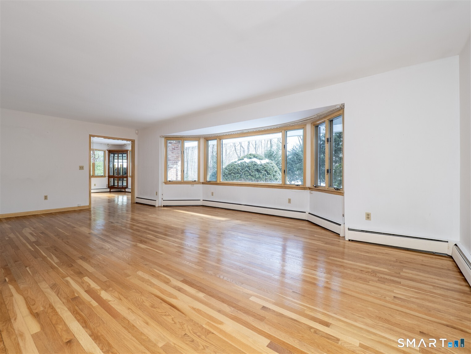 78 Ruscoe Road Wilton, CT 06897 - Photo 19 of 40 a view of an empty room with wooden floor and a window