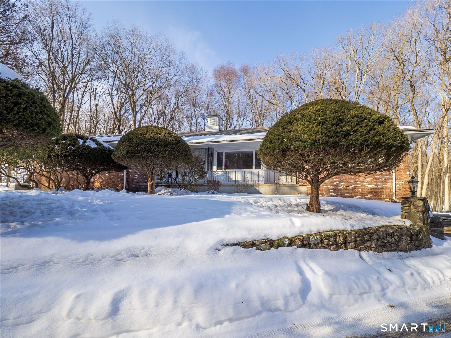 78 Ruscoe Road Wilton, CT 06897 - Photo 2 of 40 a front view of house with yard and trees around