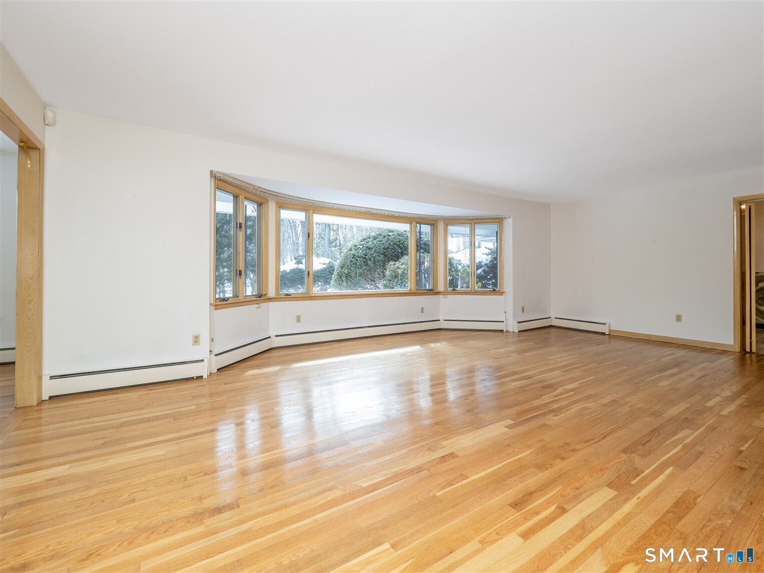 78 Ruscoe Road Wilton, CT 06897 - Photo 21 of 40 a view of an empty room with wooden floor and a window