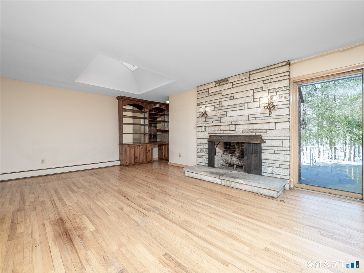 78 Ruscoe Road Wilton, CT 06897 - Photo 24 of 40 a view of an empty room with a fireplace and a window